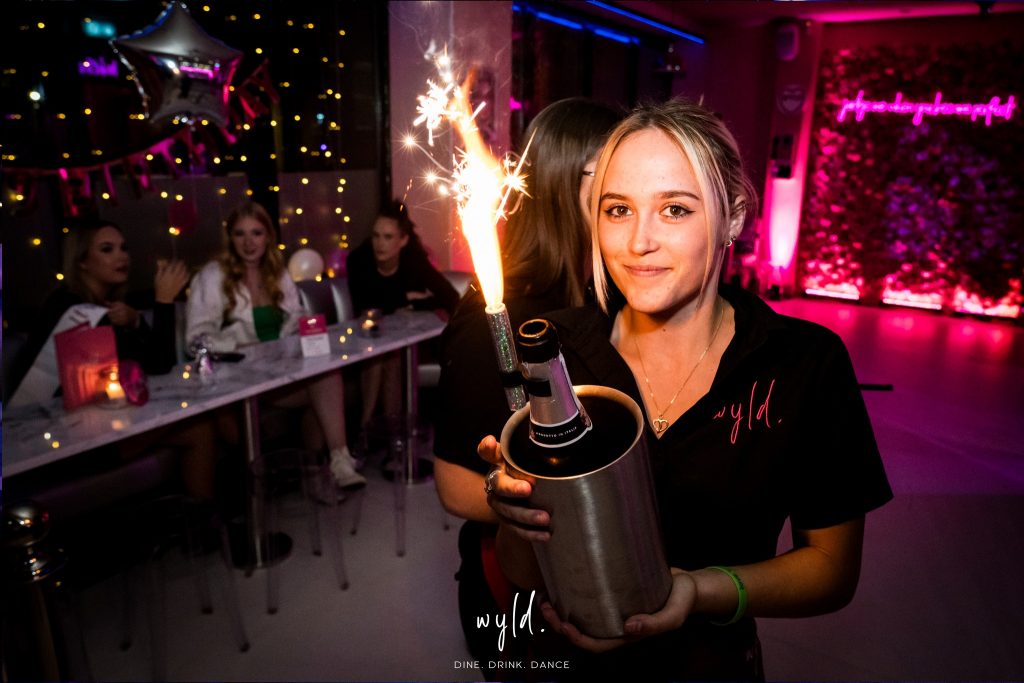 Girl carrying Prosecco with Sparkler